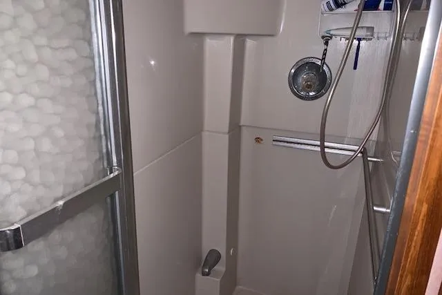 Slide: The Image of Shower area in 1987 Sea Ray 410 Aft Cabin yacht, featuring a sliding glass door. - 26