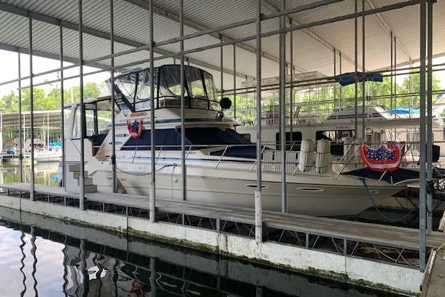 Slide: The Image of 1987 Sea Ray 410 Aft Cabin yacht docked in a covered marina. - 5