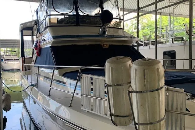 Slide: The Image of 1987 Sea Ray 410 Aft Cabin yacht docked in a covered marina. - 6
