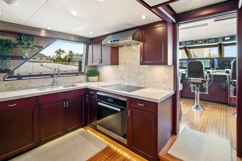 Slide: The Image of Luxurious 2002 NorthCoast Pilothouse Motoryacht kitchen with modern appliances and elegant wood cabinetry. - 29