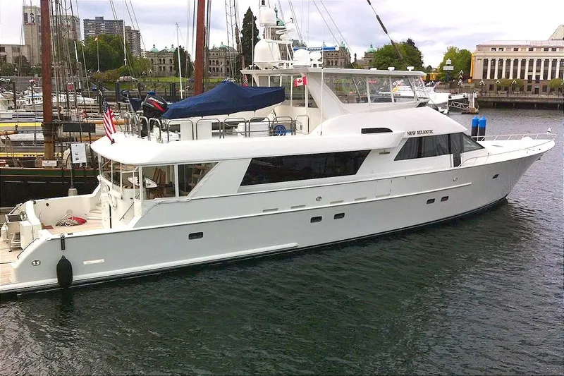 Slide: The Image of A luxurious motor yacht with a raised pilothouse docked in the harbor. - 4