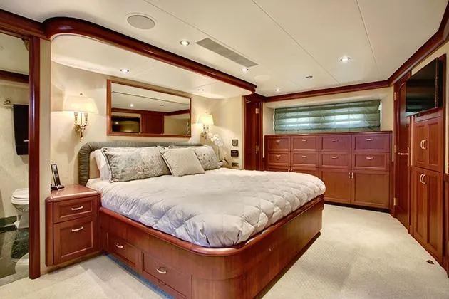 Slide: The Image of Luxurious bedroom with a large bed, wooden furniture, and soft lighting on a yacht. - 33