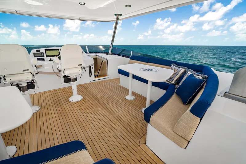Slide: The Image of Luxurious 2002 NorthCoast Pilothouse Motoryacht deck with seating, ocean view, and helm station. - 9