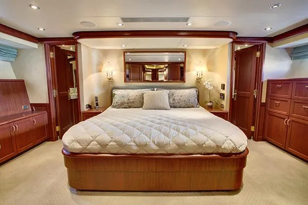 Slide: The Image of Luxurious bedroom with wooden furnishings and a large bed on a yacht. - 32