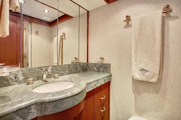 Slide: The Image of Luxurious bathroom with marble sink and wooden cabinets on a yacht. - 37