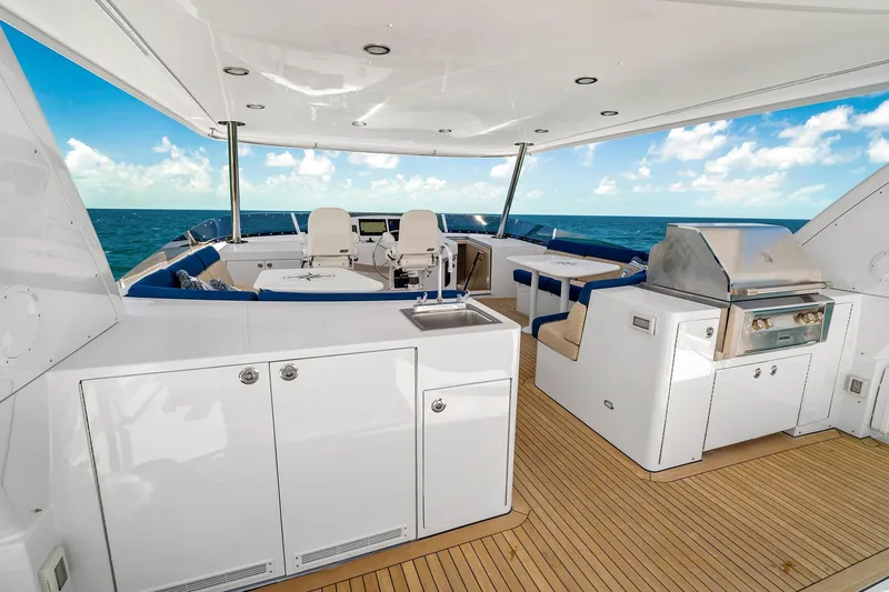 Slide: The Image of Luxurious 2002 NorthCoast Pilothouse Motoryacht deck with seating, grill, and ocean view. - 12