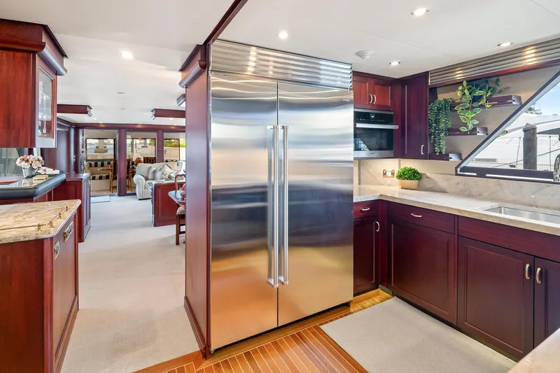 Slide: The Image of Luxurious 2002 NorthCoast Pilothouse Motoryacht kitchen with stainless steel appliances and elegant wood cabinetry. - 28