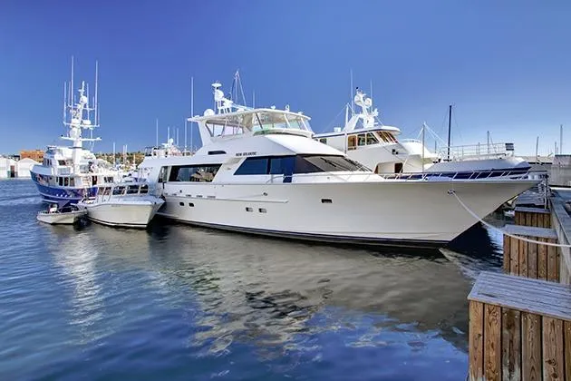 Slide: The Image of Luxurious motor yacht with raised pilothouse, built in 2002, docked in a harbor. - 5