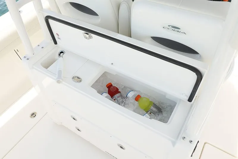 Slide: The Image of 2024 Cobia 301 CC boat cooler with drinks and ice. - 10