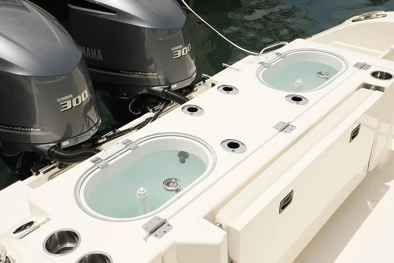 Slide: The Image of 2024 Cobia 301 CC boat with twin Yamaha 300 engines and live wells. - 5
