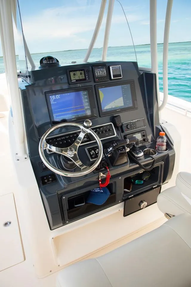 Slide: The Image of 2024 Cobia 301 CC boat dashboard with advanced navigation and control systems. - 7