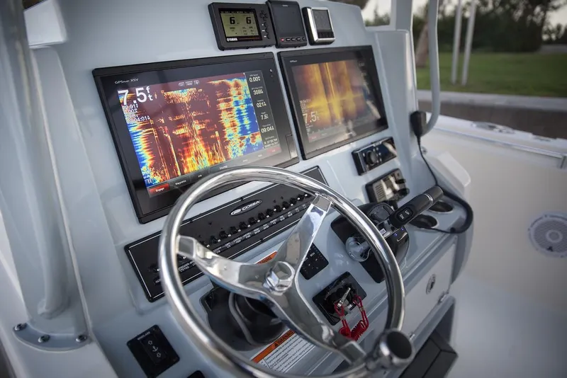 Slide: The Image of Cobia 320 CC 2024 boat dashboard with advanced navigation and control systems. - 10