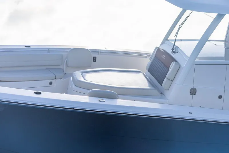 Slide: The Image of 2024 Cobia 350 CC boat interior with cushioned seating and sleek design. - 10