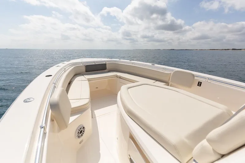 Slide: The Image of 2024 Cobia 350 CC boat with spacious seating on open water. - 12