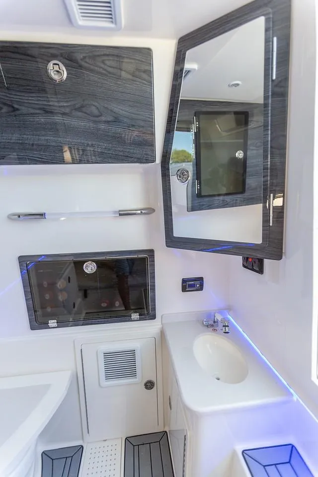Slide: The Image of 2024 Cobia 350 CC boat bathroom with modern fixtures and sleek design. - 6