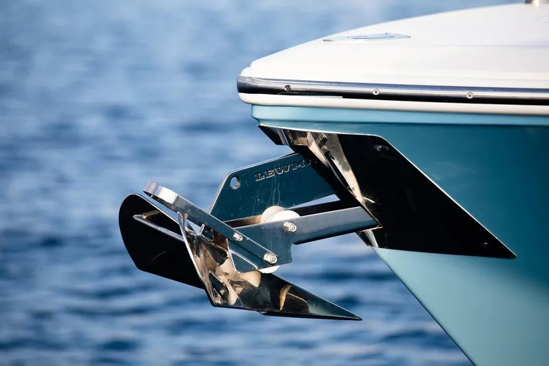 Slide: The Image of Close-up of 2024 Cobia 350 CC boat anchor against blue water. - 9