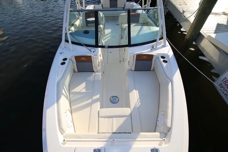 Slide: The Image of 2024 Cobia 280 Dual Console boat with spacious seating and sleek design. - 2