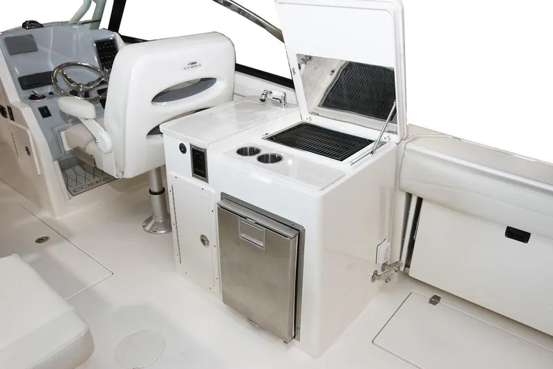 Slide: The Image of 2024 Cobia 280 Dual Console interior with helm, sink, and storage. - 6