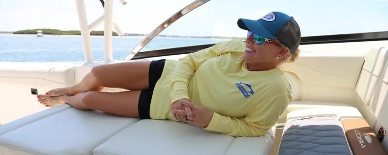 Slide: The Image of Person relaxing on a 2024 Cobia 280 Dual Console boat. - 9
