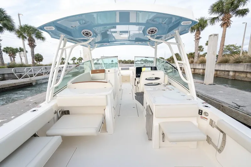 Slide: The Image of 2024 Cobia 330 Dual Console boat interior with seating and amenities. - 15