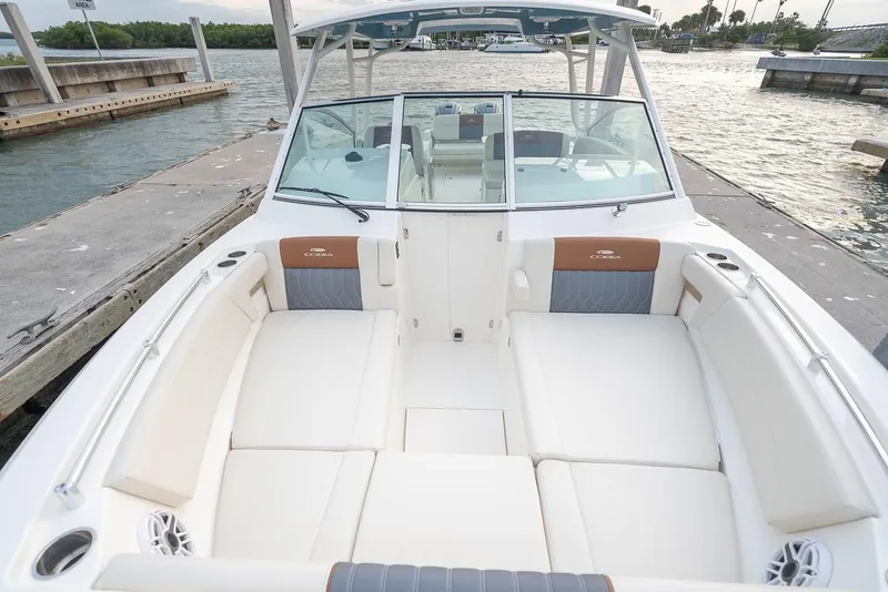 Slide: The Image of 2024 Cobia 330 Dual Console boat with spacious seating at the dock. - 18