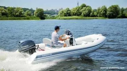 Slide: The Image of 2024 Grand Inflatables S420 boat cruising on a lake. - 7