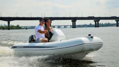 The Image of 2024 Grand Inflatables S330 boat cruising on a river with two people. - 1