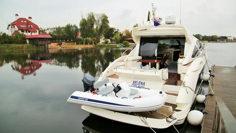 Slide: The Image of Luxury yacht with 2024 Grand Inflatables S330 docked on calm waters. - 5