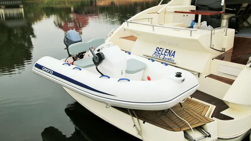 Slide: The Image of 2024 Grand Inflatables S330 boat docked on a yacht. - 6