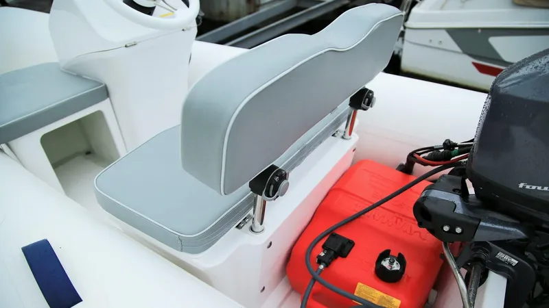 Slide: The Image of 2024 Grand Inflatables S330 boat interior with grey seating and red fuel tank. - 7