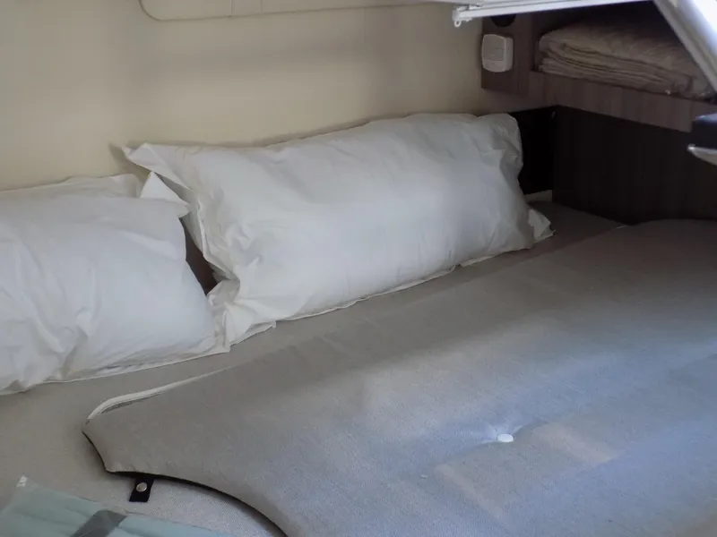 Slide: The Image of 2022 Regal 28 Express cabin interior with comfortable bedding and pillows. - 11