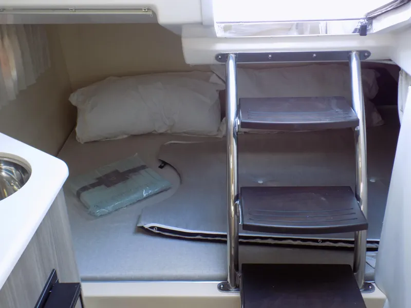 Slide: The Image of 2022 Regal 28 Express cabin interior with bed and ladder. - 12