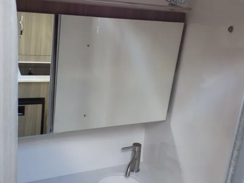 Slide: The Image of Bathroom interior of 2022 Regal 28 Express boat with modern sink and mirror cabinet. - 14