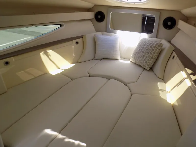 Slide: The Image of 2022 Regal 28 Express cabin interior with plush seating and pillows. - 9