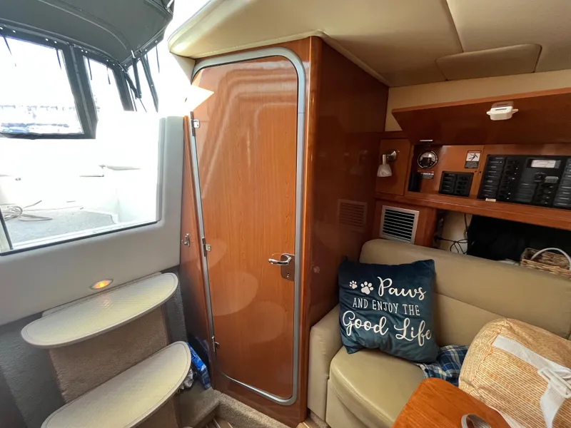 Slide: The Image of Interior of 2009 Maxum 3100 SE boat with cozy seating and wooden cabinetry. - 11