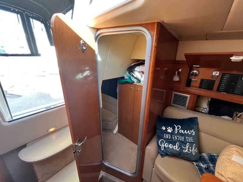 Slide: The Image of 2009 Maxum 3100 SE cabin interior with cozy seating and decorative pillow. - 12