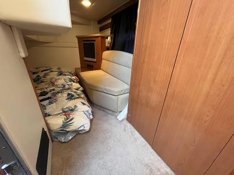 Slide: The Image of 2009 Maxum 3100 SE cabin interior with bed, sofa, and TV. - 14
