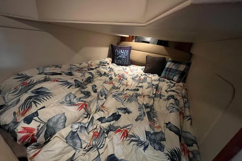 Slide: The Image of Cozy sleeping quarters in a 2009 Maxum 3100 SE boat with floral bedding. - 15
