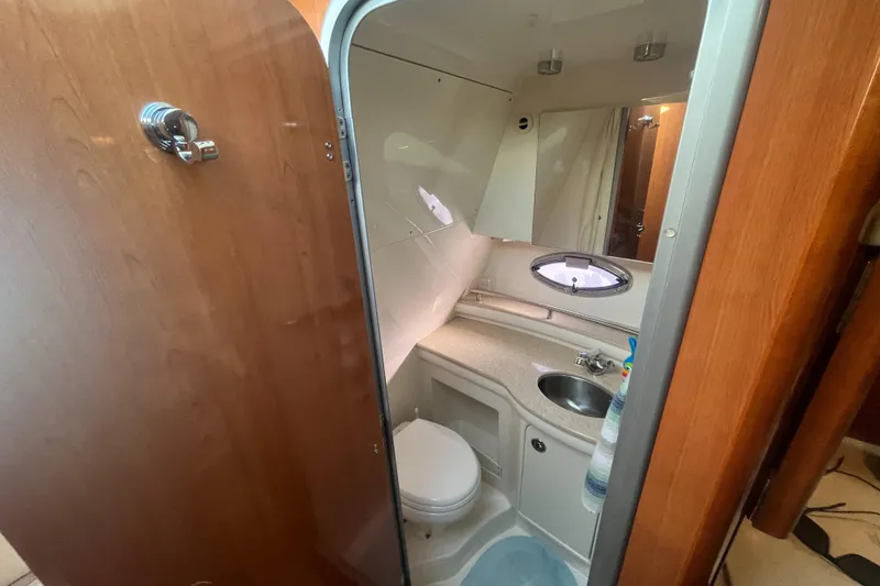 Slide: The Image of 2009 Maxum 3100 SE boat bathroom with sink, toilet, and mirror. - 17