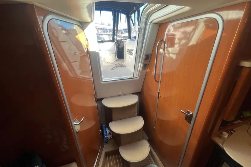 Slide: The Image of Interior of a 2009 Maxum 3100 SE boat with wooden cabinetry and steps. - 18