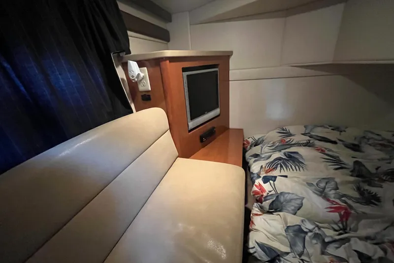Slide: The Image of Interior cabin of 2009 Maxum 3100 SE with TV, bed, and seating. - 20