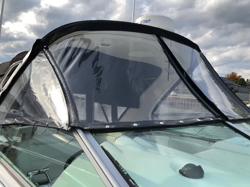 Slide: The Image of 2009 Maxum 3100 SE boat with clear windshield and black trim. - 3