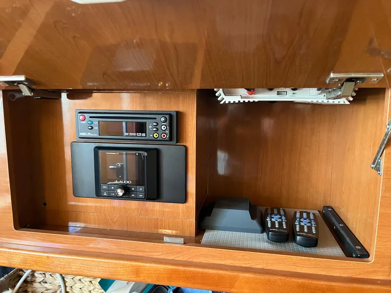 Slide: The Image of Entertainment system in 2009 Maxum 3100 SE boat with remotes and control panel. - 30