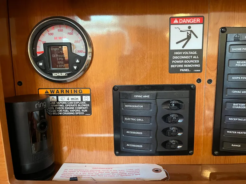 Slide: The Image of Control panel of a 2009 Maxum 3100 SE boat with warning labels and switches. - 32