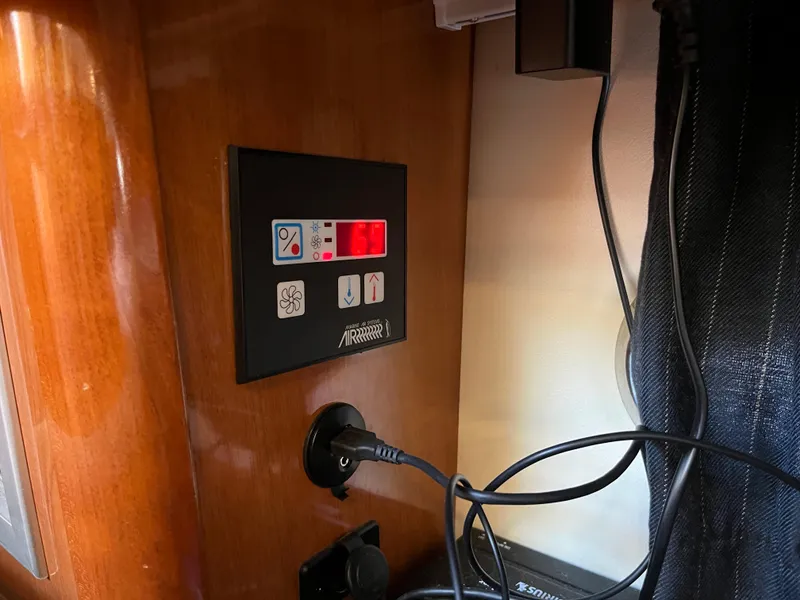Slide: The Image of Control panel and power outlet inside a 2009 Maxum 3100 SE boat cabin. - 33
