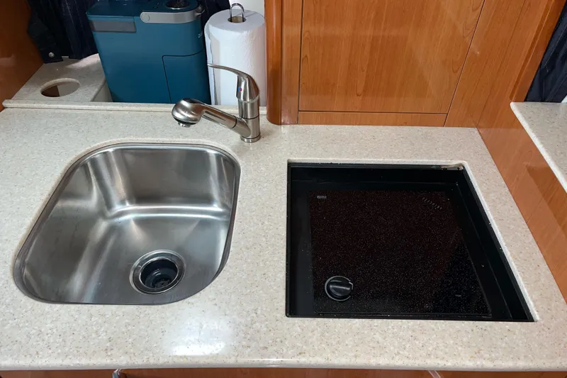 Slide: The Image of 2009 Maxum 3100 SE galley with stainless steel sink and stovetop. - 37