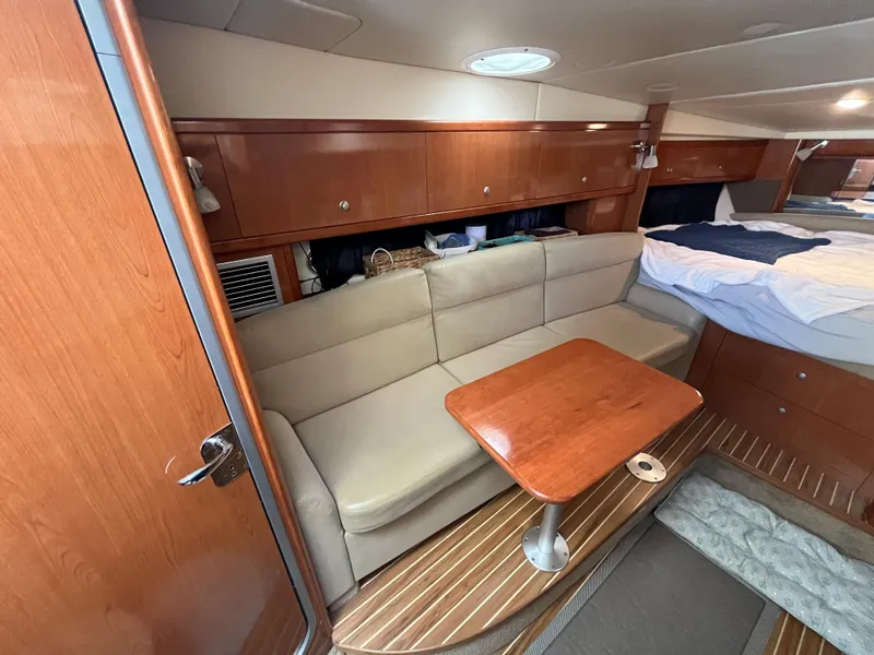 Slide: The Image of 2009 Maxum 3100 SE cabin interior with beige sofa and wooden table - 40