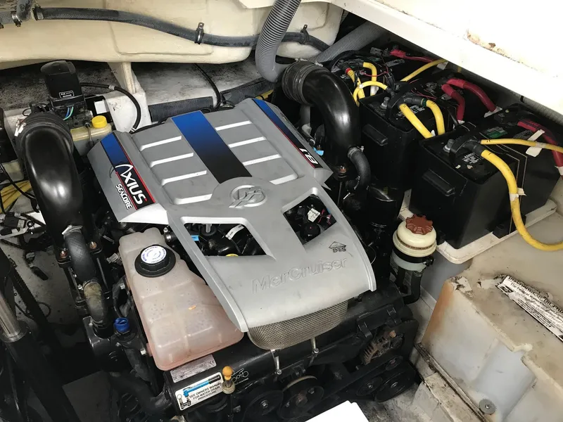 Slide: The Image of 2009 Maxum 3100 SE engine compartment with MerCruiser engine and battery setup. - 43
