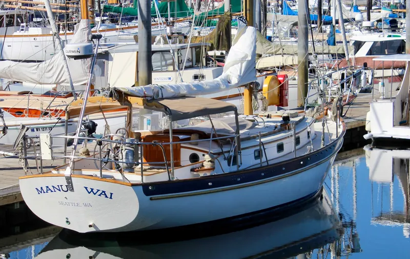 The Image of 1988 Cape George 38 sailboat docked in a marina, surrounded by other boats. - 0