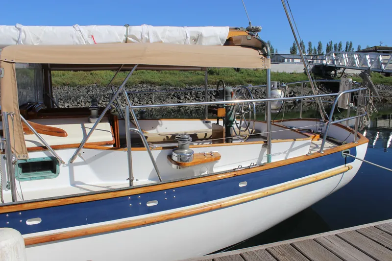 Slide: The Image of 1988 Cape George 38 sailboat docked, featuring classic design and wooden accents. - 10